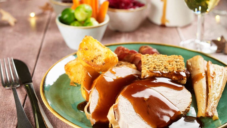 A traditional Christmas lunch with turkey, potatoes, stuffing and gravy